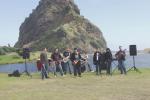 John Goudge Band at a video shoot at Piha - the magnificent Lion Rock in the background.